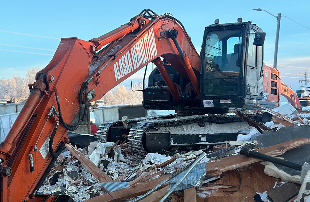 Excavator on top of rubble