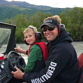 Man and his son on a river boat