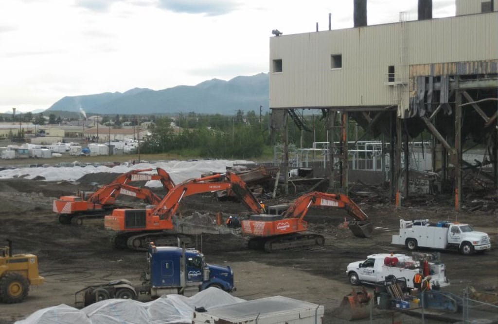 Excavators demolishing power plant