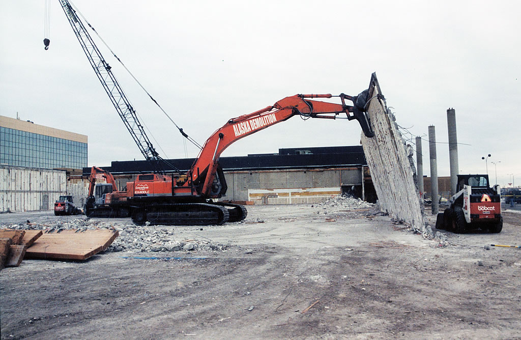 Excavator pulling down wall