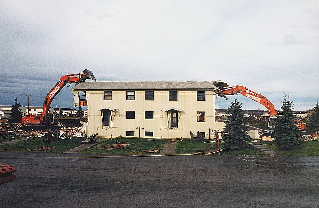 Excavators tearing down building on both sides