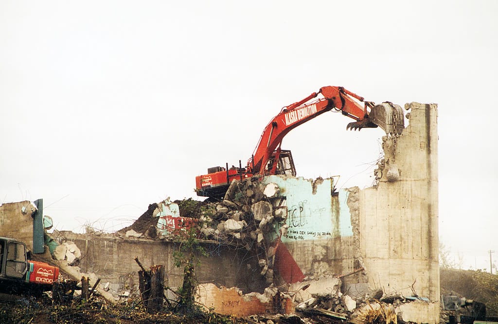 Excavator destroying a building