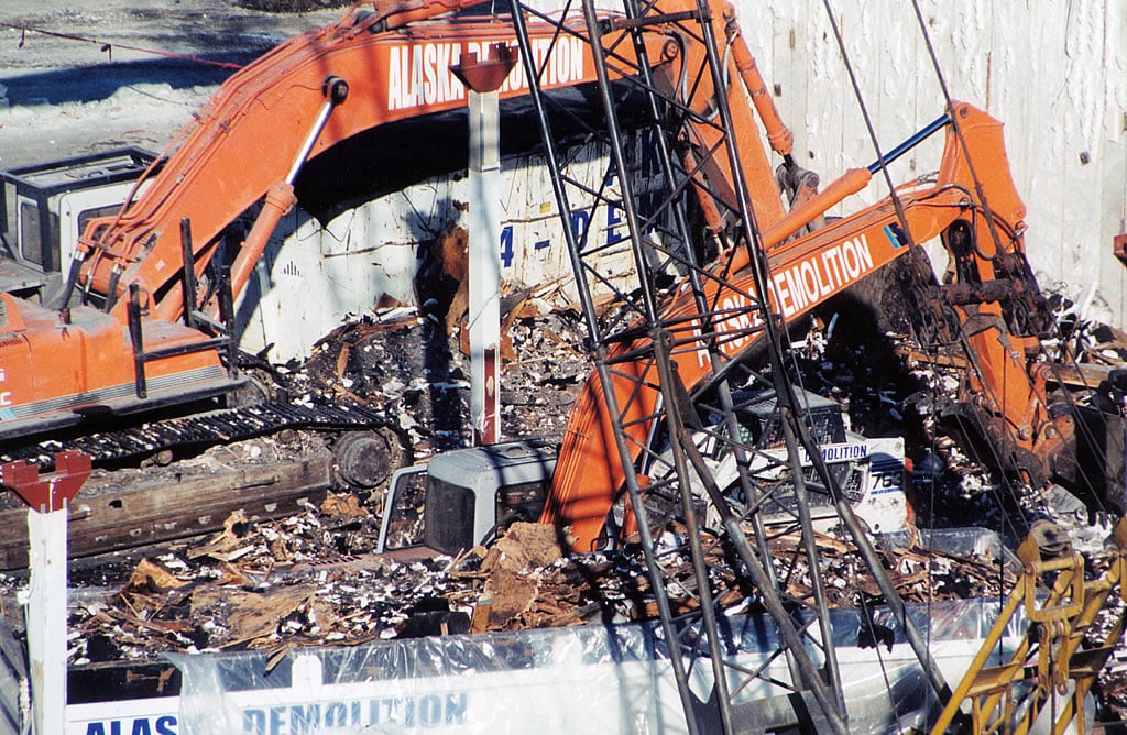 Excavators and skid steer at demolition site