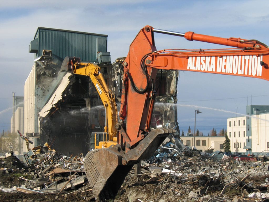 Excavators destroying buildings