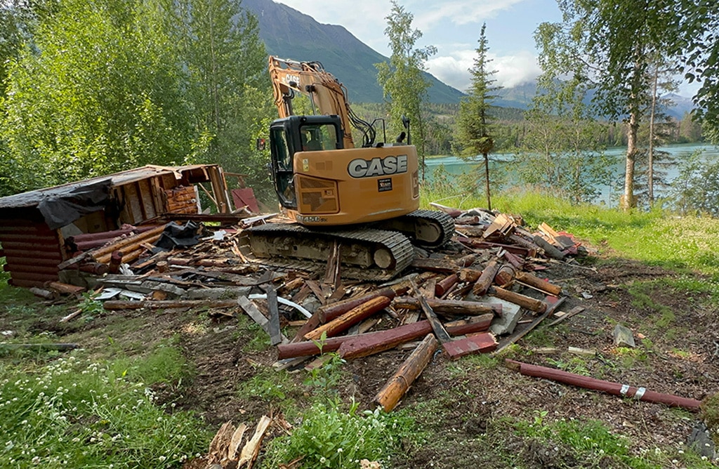 Mini excavator on many logs