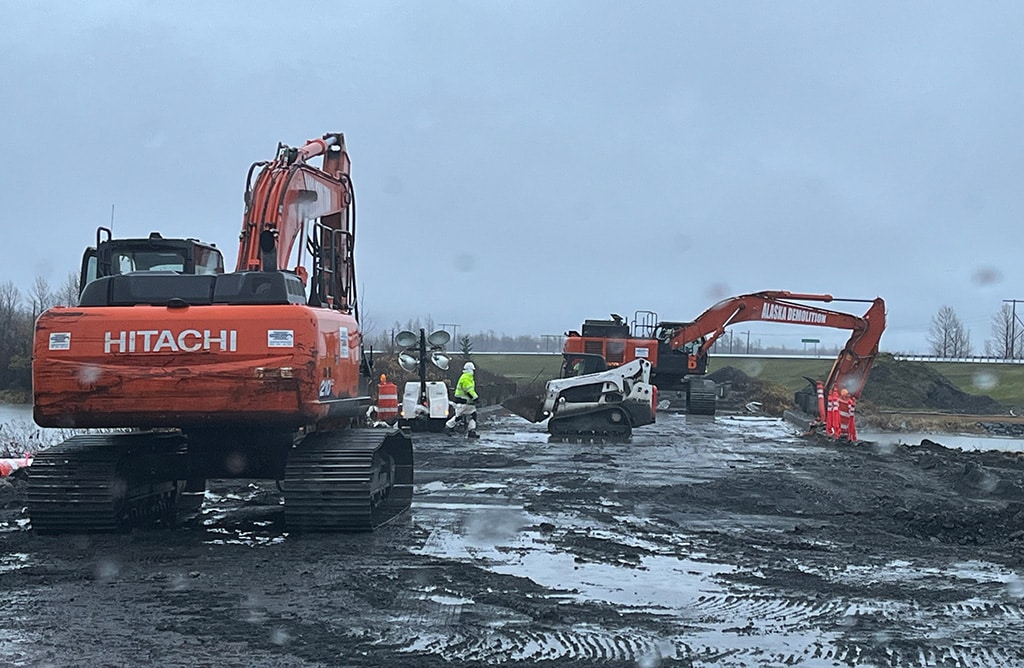 Excavators working in the rain